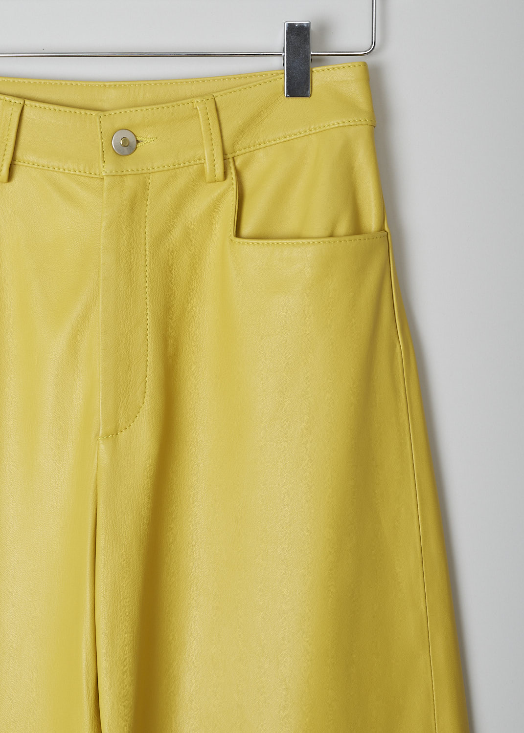 WANDLER, CHAMOMILE HOLIDAY PANTS, 22306_060301_1434_CHAMOMILE_HOLIDAY, Yellow, Detail, These yellow leather Chamomile pants have a waistband with belt loops and a button and zip closure. The pants have a high-waisted fit. The balloon legs are cropped at the ankle. These pants have slanted pockets in the front and patch pockets in the back. 


