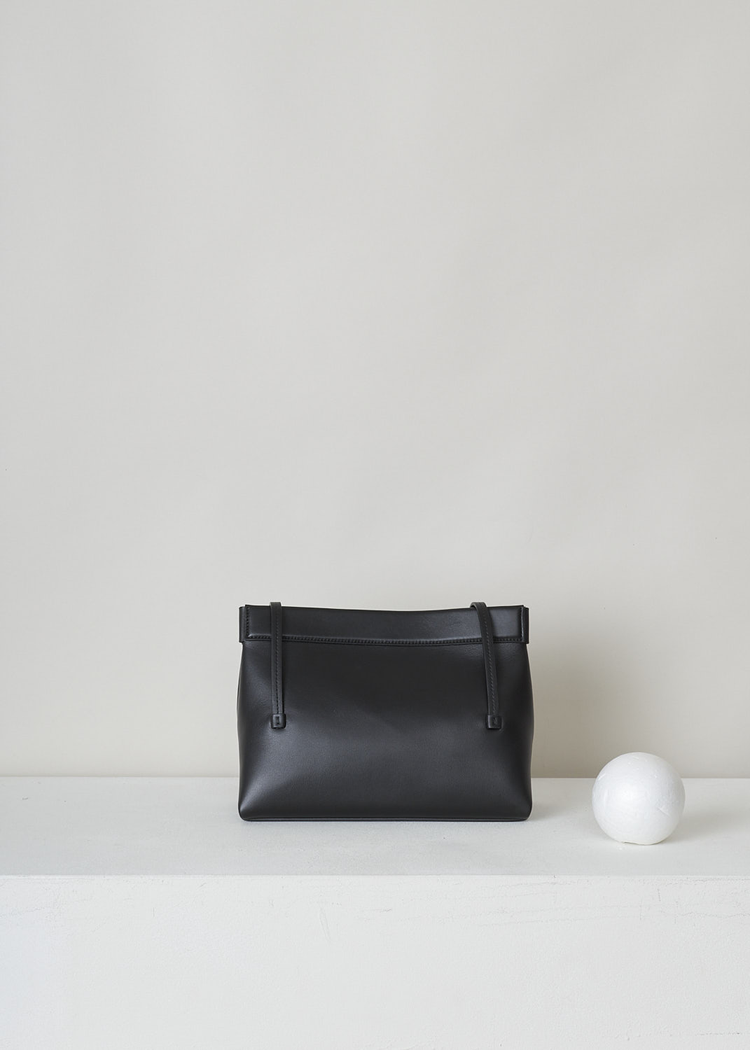 WANDLER, JOANNA MINI BAG IN BLACK, JOANNA_BAG_MINI_BLACK_22108100391, Black, Back, This black Joanna mini hand bag has slim top handles. The magnetic strip closure opens up to the single spacious compartment. On the front, the brand's lettering can be found in gold.  

